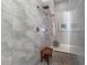 Luxurious shower with dual shower heads, stone tile surround, and a built-in bench at 1104 Isobel Reserve Ln, Tampa, FL 33613