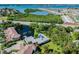 Beautiful aerial view capturing the community's pool and amenities amidst lush greenery and waterfront vistas at 11162 Kapok Grand Cir, Madeira Beach, FL 33708