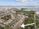 Aerial view of townhouse complex near water, showcasing location and community layout at 11162 Kapok Grand Cir, Madeira Beach, FL 33708
