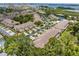 Scenic aerial view of a condo community with lush landscaping, serene pond, and glimpses of the bay at 11162 Kapok Grand Cir, Madeira Beach, FL 33708