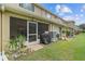 Exterior view of a private screened patio with access to a well-manicured lawn and community surroundings at 11162 Kapok Grand Cir, Madeira Beach, FL 33708