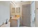 Small bathroom featuring a single sink vanity with a mirror, and a doorway view into another room at 11162 Kapok Grand Cir, Madeira Beach, FL 33708