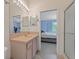 Bathroom featuring a large mirror, single vanity, and a doorway view into the bedroom and stand-up shower at 11162 Kapok Grand Cir, Madeira Beach, FL 33708