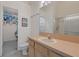 Cozy bathroom with a single sink vanity, large mirror, and shower with sliding glass door at 11162 Kapok Grand Cir, Madeira Beach, FL 33708