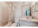 Bathroom with shower-tub combination, neutral tile, and a vanity providing a clean and functional space at 11162 Kapok Grand Cir, Madeira Beach, FL 33708