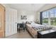 This bedroom is well-lit with a large window providing natural light and a desk, creating an organized space at 11162 Kapok Grand Cir, Madeira Beach, FL 33708
