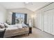 Bright bedroom with vaulted ceilings, plush carpet, and a large window offering natural light and a serene view at 11162 Kapok Grand Cir, Madeira Beach, FL 33708