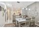 Bright dining area with wooden table, pendant lighting, and view of kitchen and entryway at 11162 Kapok Grand Cir, Madeira Beach, FL 33708