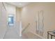 Well-lit hallway leading to bedrooms, complemented by decorative mirrors and neutral tones at 11162 Kapok Grand Cir, Madeira Beach, FL 33708