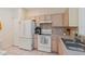 Bright kitchen featuring light cabinets, essential appliances, and ample counter space at 11162 Kapok Grand Cir, Madeira Beach, FL 33708