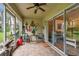 Relaxing enclosed lanai with nautical decorations, tile floor, and outside view at 11162 Kapok Grand Cir, Madeira Beach, FL 33708