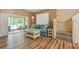 Open-concept living room with hardwood floors, a sleeper sofa, and access to the screened lanai at 11162 Kapok Grand Cir, Madeira Beach, FL 33708