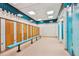 Clean locker room featuring wooden lockers and teal accents at 11162 Kapok Grand Cir, Madeira Beach, FL 33708