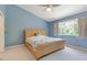 Comfortable bedroom with a vaulted ceiling, a woven headboard, and plenty of natural light at 11162 Kapok Grand Cir, Madeira Beach, FL 33708