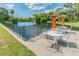 Lakeside patio area featuring tables and umbrellas at 11162 Kapok Grand Cir, Madeira Beach, FL 33708