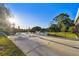 Community lakeside patio area with tables and umbrellas at 11162 Kapok Grand Cir, Madeira Beach, FL 33708