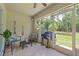 Cozy outdoor patio area with seating, decor, and an open view of the well-maintained lawn at 11162 Kapok Grand Cir, Madeira Beach, FL 33708