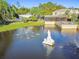 Aerial view of pond with water features and community amenities at 11162 Kapok Grand Cir, Madeira Beach, FL 33708