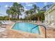 Relaxing community pool surrounded by lounge chairs and lush landscaping for ultimate leisure and enjoyment at 11162 Kapok Grand Cir, Madeira Beach, FL 33708