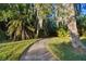 Landscaped walkway with lush foliage and greenery at 11162 Kapok Grand Cir, Madeira Beach, FL 33708