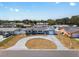 Aerial view of a charming blue single-story home with circular driveway and manicured lawn at 11762 82Nd Ter, Seminole, FL 33772