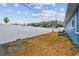 A spacious backyard features a tall white fence, shed, and ample space at 11762 82Nd Ter, Seminole, FL 33772
