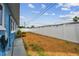 Backyard with a privacy fence, blue house, and green grass at 11762 82Nd Ter, Seminole, FL 33772