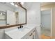 Bathroom with a white vanity, quartz countertop, and a framed mirror at 11762 82Nd Ter, Seminole, FL 33772