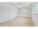 Bright bedroom featuring neutral carpeting, a window, and lots of closet space at 11762 82Nd Ter, Seminole, FL 33772