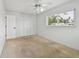 Bedroom featuring carpet, ceiling fan with light fixture, and bright window at 11762 82Nd Ter, Seminole, FL 33772