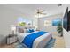 Modern bedroom with neutral tones, a cozy bed, and a view of the outside at 11762 82Nd Ter, Seminole, FL 33772
