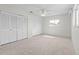 Cozy bedroom with carpeted floors, ceiling fan, and bright window at 11762 82Nd Ter, Seminole, FL 33772