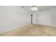 Bedroom with neutral carpet, ceiling fan, and access to additional room at 11762 82Nd Ter, Seminole, FL 33772