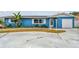 Charming single-story home with a blue facade, well-maintained landscaping, and a private driveway at 11762 82Nd Ter, Seminole, FL 33772