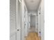 Bright hallway with wood floors, closet with louvered doors, and white trim at 11762 82Nd Ter, Seminole, FL 33772