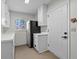 This kitchen features white cabinets, a black refrigerator, and a stained-glass window at 11762 82Nd Ter, Seminole, FL 33772