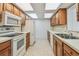 Functional kitchen with white appliances, wooden cabinetry, and bright lighting creating a practical space at 11762 82Nd Ter, Seminole, FL 33772