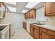 Well-equipped kitchen featuring wooden cabinets, ample countertop space, and essential appliances for meal preparation at 11762 82Nd Ter, Seminole, FL 33772