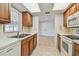 Classic kitchen design with wooden cabinetry, white appliances, and a view into a bright and open living space at 11762 82Nd Ter, Seminole, FL 33772