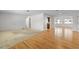 Spacious living room featuring carpet and hardwood flooring flowing into sunroom with bright natural light at 11762 82Nd Ter, Seminole, FL 33772