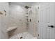 Beautifully tiled shower with rainfall showerhead and built-in seat at 11762 82Nd Ter, Seminole, FL 33772