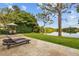 Serene backyard with lush landscaping, outdoor seating, and relaxing water views at 11817 Glen Wessex Ct, Tampa, FL 33626
