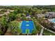 Community basketball court in a lush setting featuring a well-maintained court, lighting and shaded seating at 11817 Glen Wessex Ct, Tampa, FL 33626