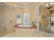 Bathroom features a soaking tub, tiled shower, and natural light from a window at 11817 Glen Wessex Ct, Tampa, FL 33626