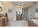 Elegant bathroom featuring granite counters, tile flooring, a glass shower, and a soaking tub at 11817 Glen Wessex Ct, Tampa, FL 33626