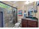 Bathroom featuring a glass-enclosed shower and granite-topped vanity, designed with modern fixtures at 11817 Glen Wessex Ct, Tampa, FL 33626