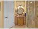 Bathroom featuring a vanity with a decorative mirror and glass enclosed shower at 11817 Glen Wessex Ct, Tampa, FL 33626