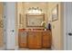 Bathroom vanity featuring granite counters, bronze fixtures, and decorative mirror at 11817 Glen Wessex Ct, Tampa, FL 33626