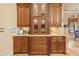 Detailed cabinetry with glass inserts, granite countertops, and ornate details offering ample storage and counter space at 11817 Glen Wessex Ct, Tampa, FL 33626