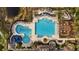 Aerial view of the resort-style community pool with water slide, lounge areas, and lush landscaping at 11817 Glen Wessex Ct, Tampa, FL 33626